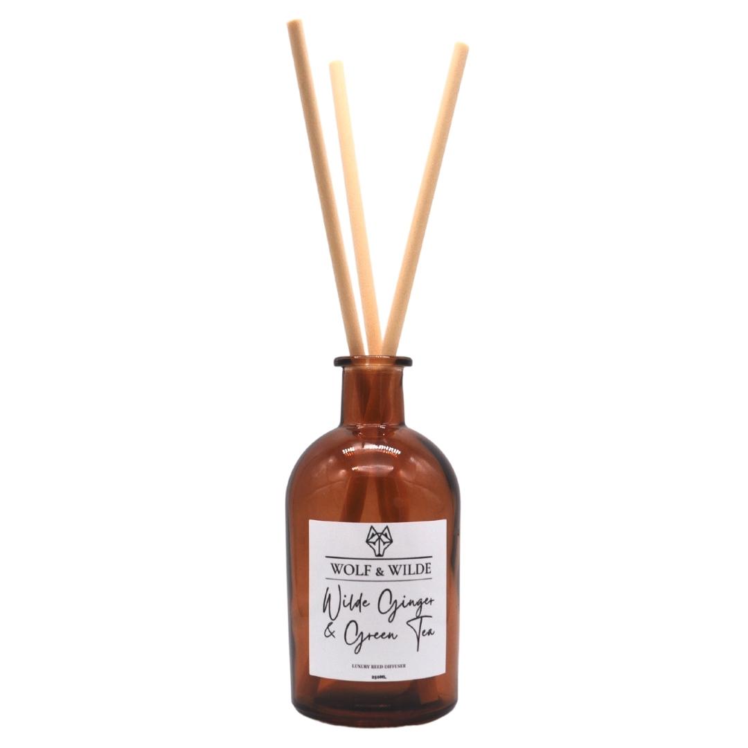 Wilde Ginger & Green Tea Apothecary Reed Diffuser in an amber bottle with natural reeds, showcasing its elegant design and eco-friendly materials.